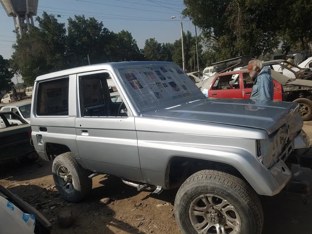 Silver Land Cruiser in the yard
